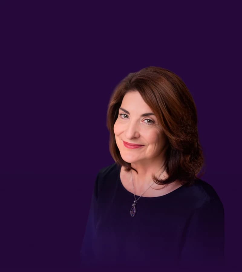 Dr. Marcia Reynolds against a purple studio backdrop.