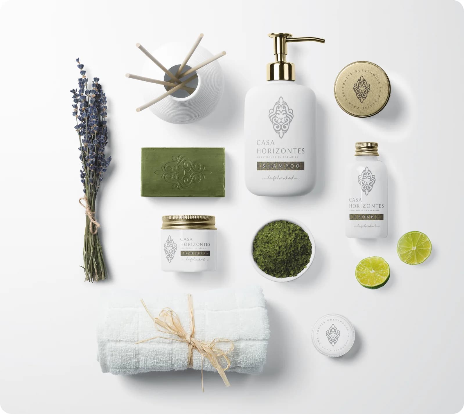 The Casa Horizontes toiletry range laid out flat with lavender, soap, limes and folded towels.