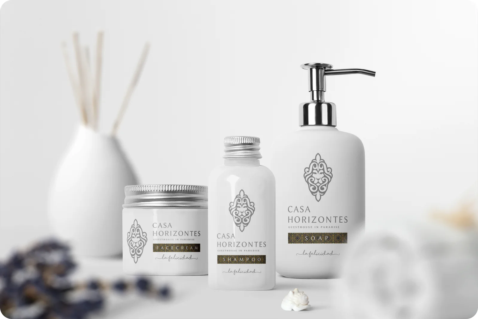 Casa Horizontes branded amenities — a body-cream jar, shampoo bottle and soap dispenser on a bright shelf.