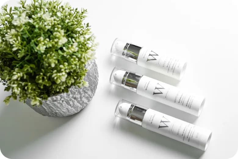 MySkin serum vials arranged beside a small potted plant.