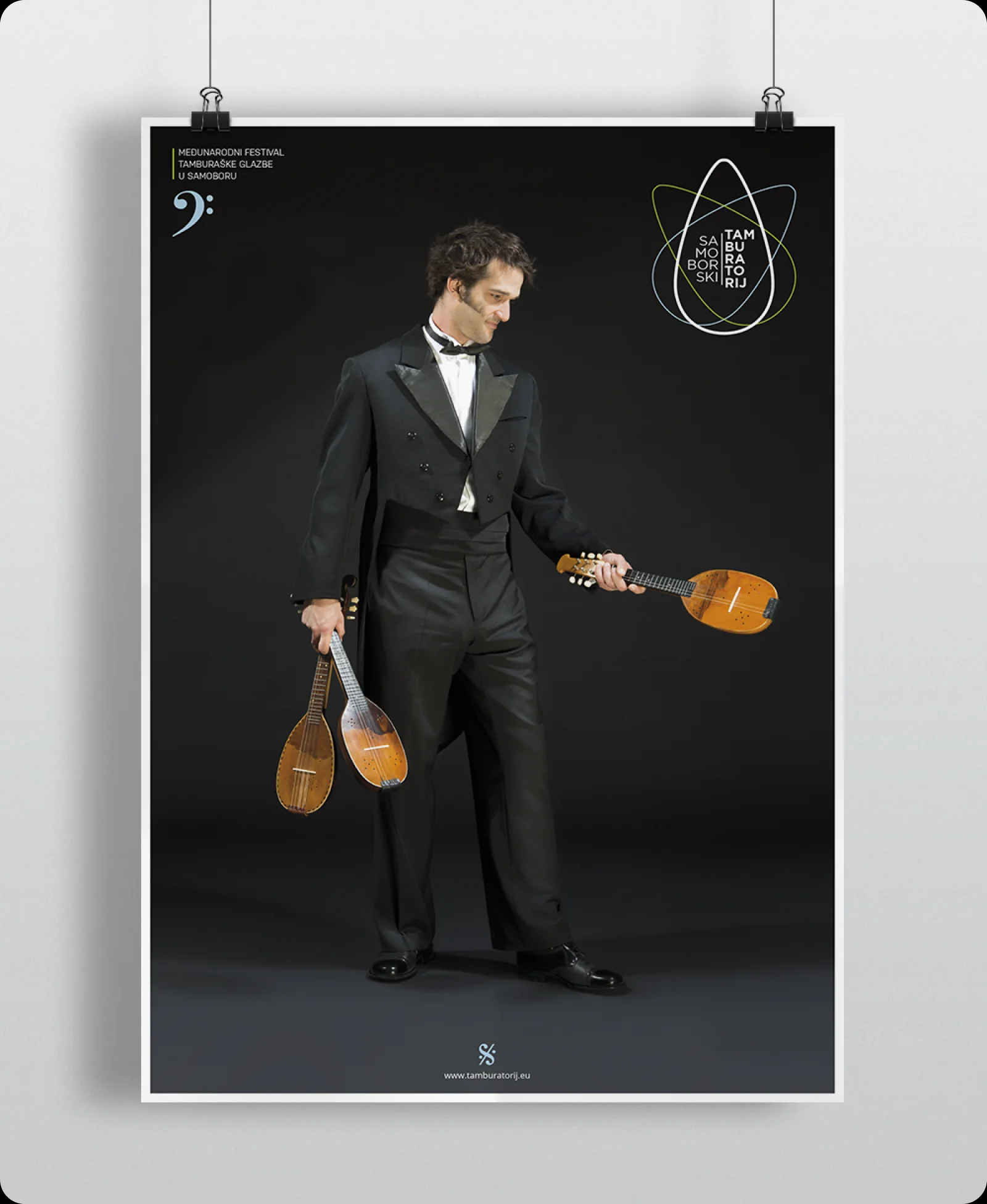 2013 festival poster: the musician standing in white tie holding two tamburitza instruments.