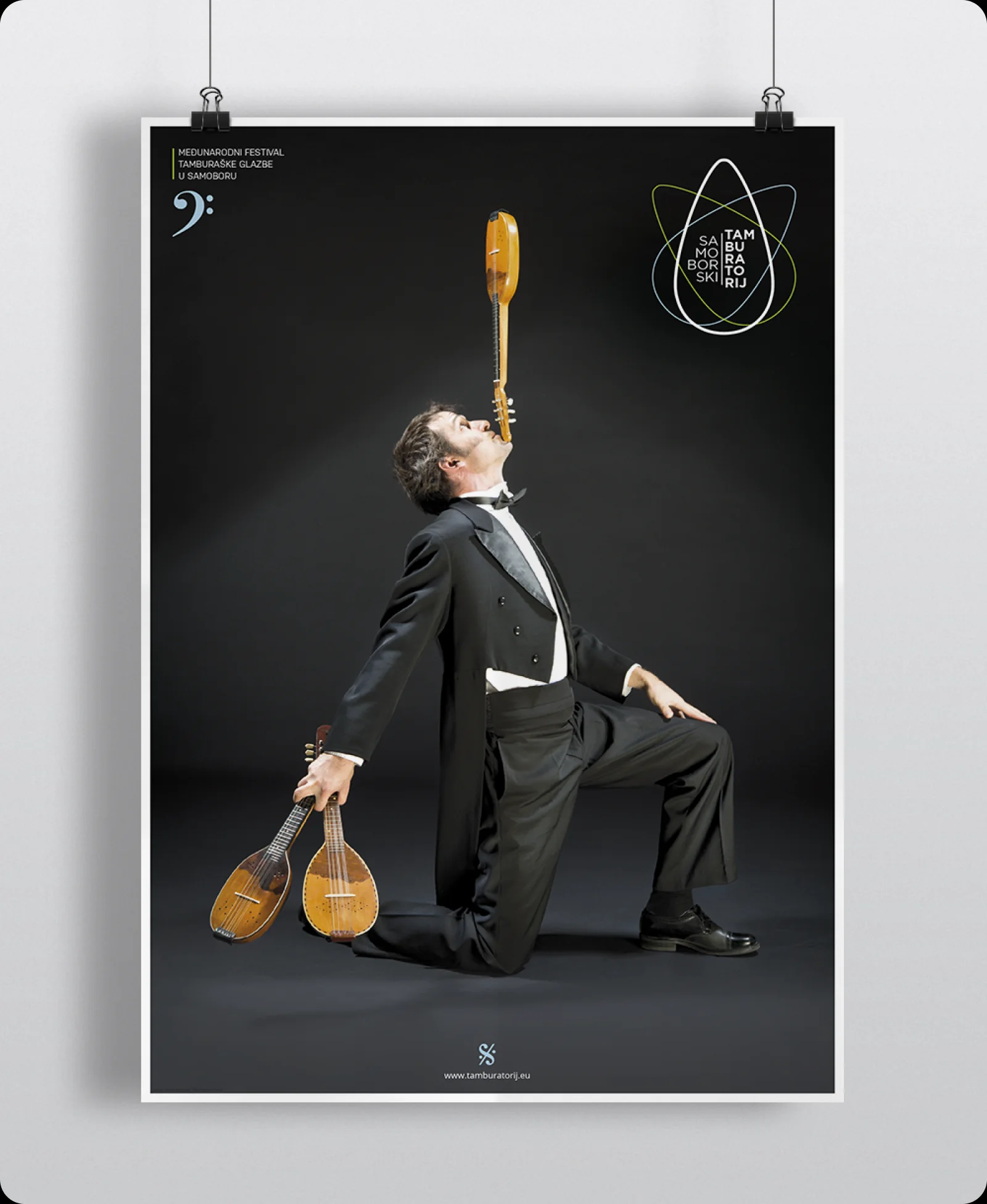 2013 festival poster: the musician kneeling and balancing a bisernica on his chin.