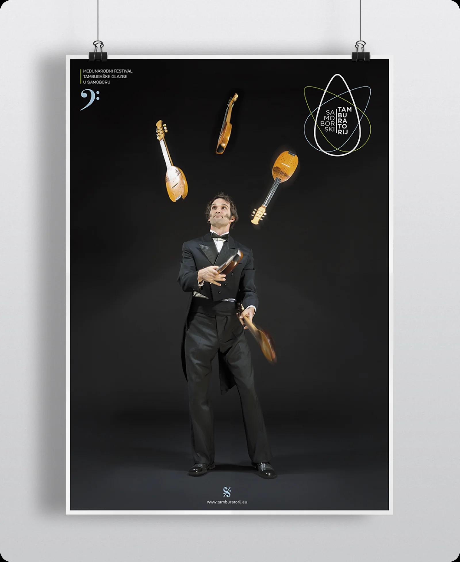 2013 festival poster: the musician with tamburitza instruments floating around him.