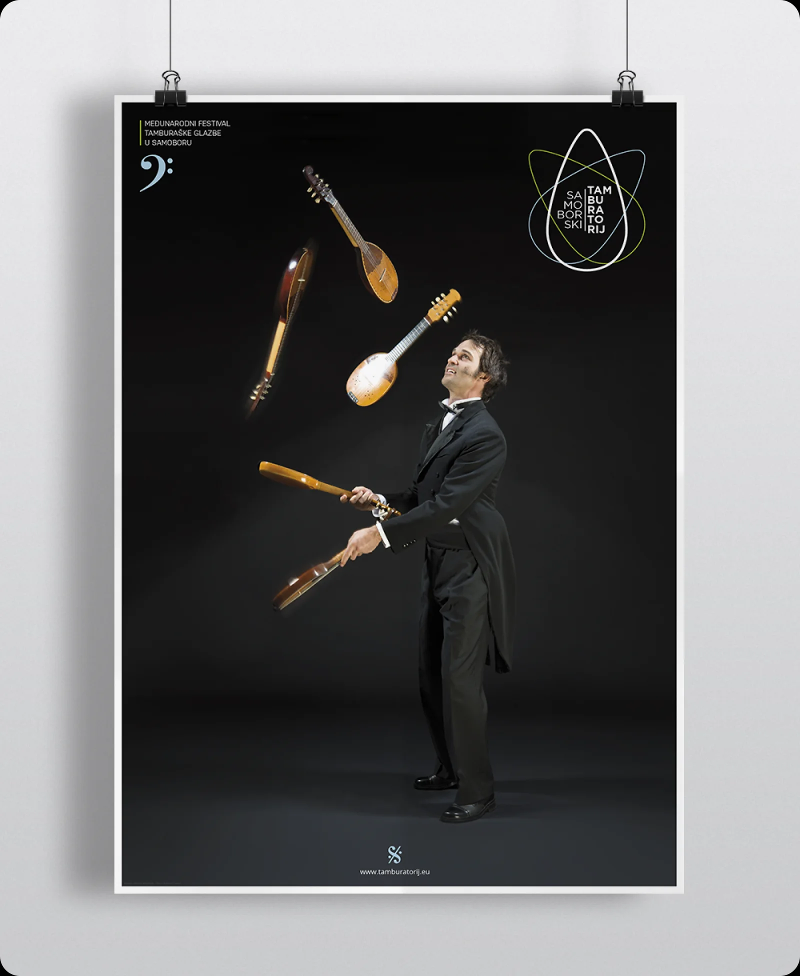 2013 festival poster: the musician juggling a set of tamburitza instruments in mid-air.
